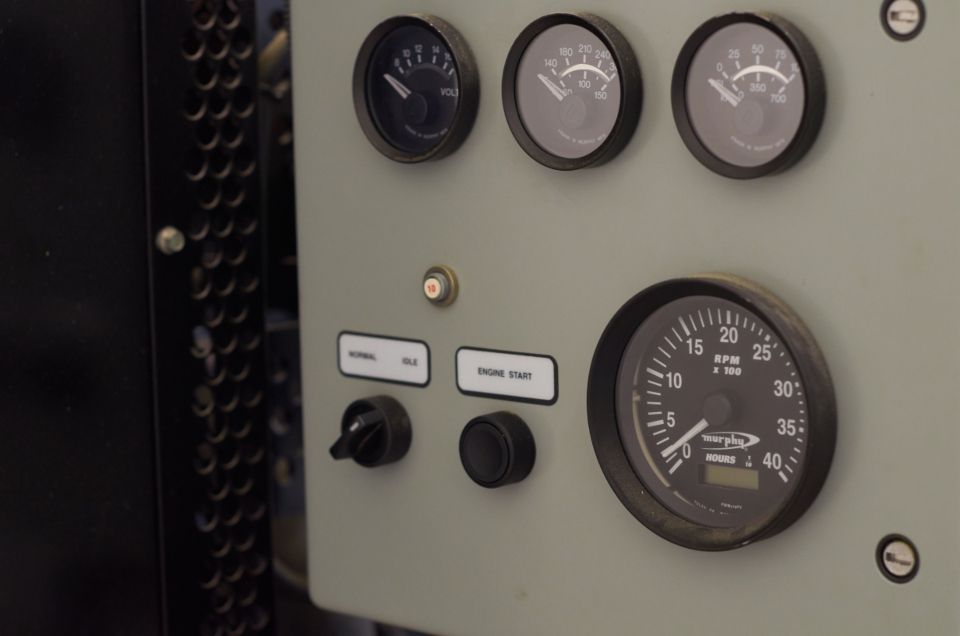 Close-up of analog gauges on a test panel